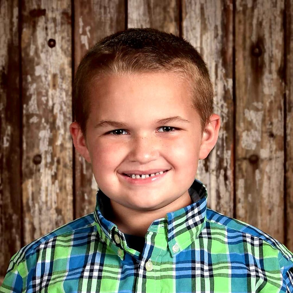 boy in plaid shirt smiling